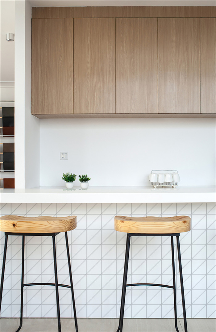 Matte white triangle tiled kitchen island design
