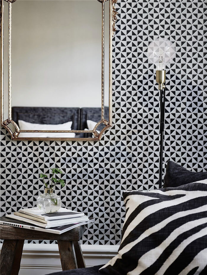 Dramatic bedroom with black white windmill pattern triangle tile wall design
