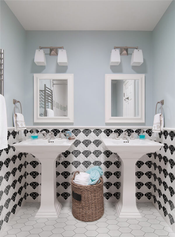 2” multi diamond black-white triangle tiles partially tiling the wall adds an unexpected design to the guest bathroom.
