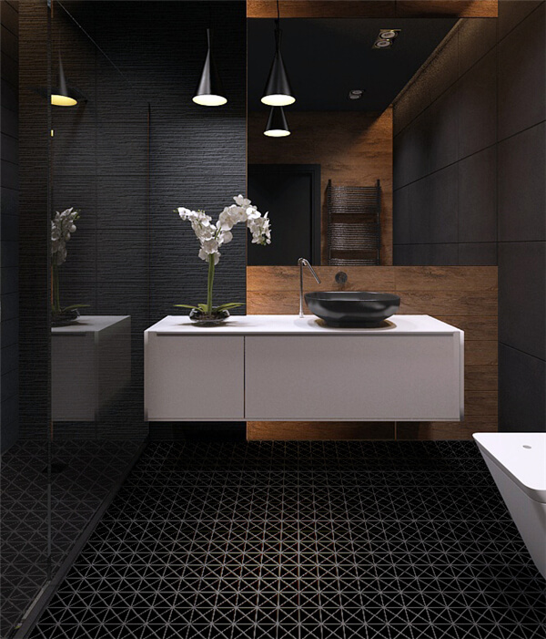 A dark bathroom done with black tile wall, white countertop and cabinets, 2” black triangular tile floor