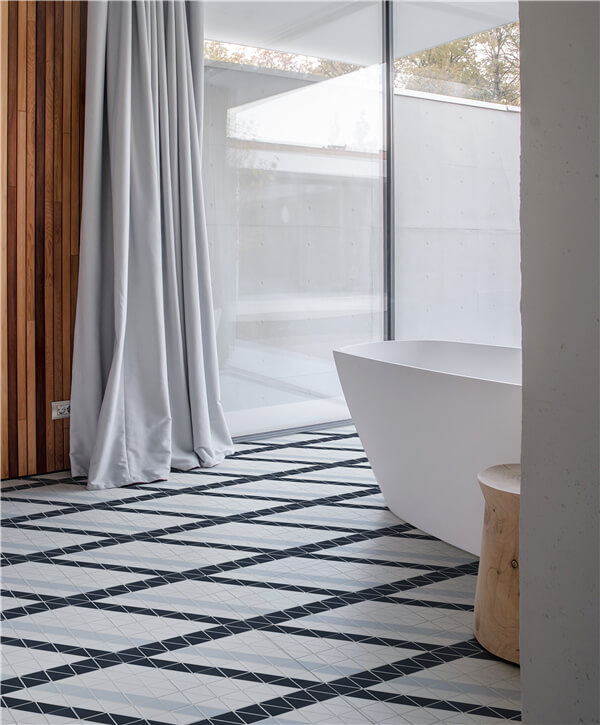 A open shower with big bathtub, flooring with 2” blue mountain ribbon geometric mosaic designs