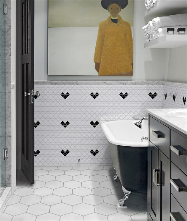 An artistic bathroom done with hanging art painting, modern black bathtub